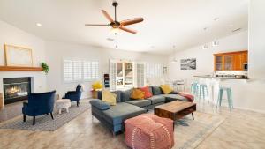 a living room with a couch and a fireplace at Hillside Desert House - Hot Tub, Fire Pit and BBQ! home in Yucca Valley