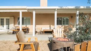a patio with chairs and a table and a hammock at Hillside Desert House - Hot Tub, Fire Pit and BBQ! home in Yucca Valley +28 photos
