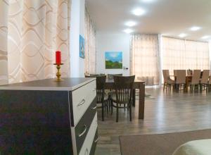 a living room and dining room with a table and chairs at Студио за четирима в село Ягодово, на 5 км от Пловдив и летище Крумово in Yagodovo