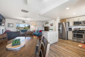 a kitchen and living room with a table and a dining room at Horseshoe House - Hot Tub, BBQ and Fire Pit! home in Joshua Tree