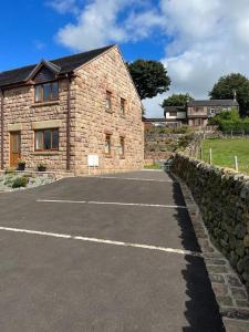 a parking lot in front of a stone building at Staycation 3-bedroom home with panoramic views free off road parking in Endon