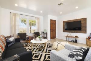 a living room with a couch and a tv at Cosmic Rabbit - Family fun with hot tub!! home in Joshua Tree