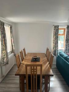 a dining room with a wooden table and chairs at Staycation 3-bedroom home with panoramic views free off road parking in Endon