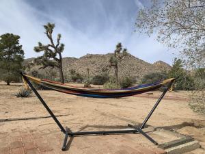 a hammock on a stand in the desert at Rocky Ridge Retreat - Hot Tub, Fire Pit & BBQ! home in Joshua Tree