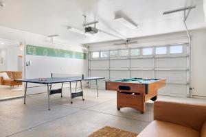 a room with two ping pong tables and a couch at Golden Desert Ranch - Hot Tub, Fire Pit and BBQ! home in Joshua Tree