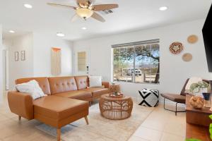 a living room with a couch and a ceiling fan at Golden Desert Ranch - Hot Tub, Fire Pit and BBQ! home in Joshua Tree
