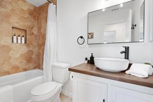 a bathroom with a sink and a toilet and a mirror at Golden Desert Ranch - Hot Tub, Fire Pit and BBQ! home in Joshua Tree +29 photos