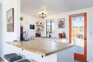 a kitchen with a large wooden counter top at Walpi Ranch - Joshua Tree Getaway with Hot Tub, Fire Pit & BBQ! home in Joshua Tree