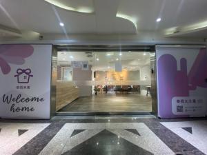 un cartello di benvenuto sulla porta di un negozio di Meworld Hotel - Daan a Taipei