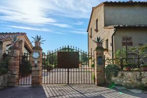 a gate to a house with a wrought iron fence at Podere Sant'Elena in San Gimignano