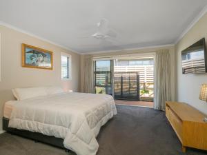 a bedroom with a large bed and a window at Relax on Roseberry - Whitianga Holiday Home in Whitianga
