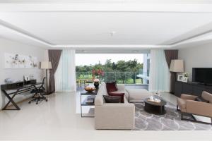 a living room with a couch and a table at North Park Serviced Apartment Bangkok in Bangkok