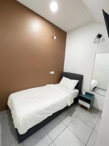 Postel nebo postele na pokoji v ubytování Gemilang Hotel Klang