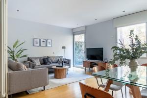 a living room with a couch and a table at Heima Retiro Park-Ibiza in Madrid