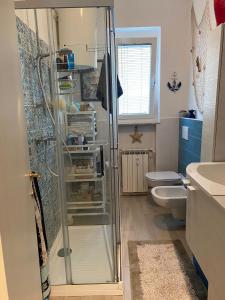 a bathroom with a shower and a toilet at Hotel Villa Venezia in Grado