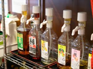 a group of four bottles of alcohol in a refrigerator at Tabist ゆ縁の宿 ふじみ in Fuji