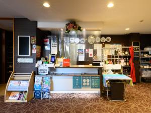 a store with a counter with books on it at Tabist ゆ縁の宿 ふじみ in Fuji