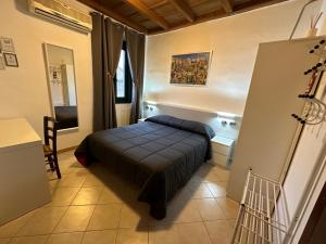 a small bedroom with a bed in a room at Hotel Duca di Tromello in Tromello