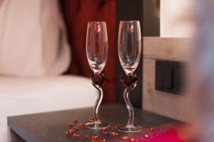 two wine glasses sitting on top of a table at Alp Larain B&B in Ischgl