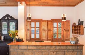 a kitchen with wooden cabinets and a counter top at Apolafsis Studios in Patmos