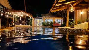 a swimming pool in a house at night at Bua Bed & Breakfast in Nadi