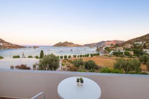 a balcony with a table and a view of the water at Apolafsis Studios in Patmos