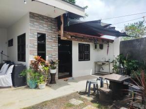 a house with a table and chairs in front of it at Yana's Place in Donsol