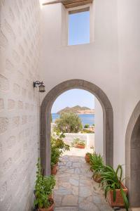 an archway in a building with a view of the ocean at Apolafsis Studios in Patmos