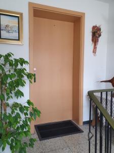 a brown door with a grate in the side of a room at FeWo Lay in Bötzingen
