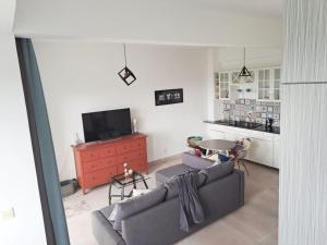a living room with a couch and a tv and a table at Seaview Modern Studio in Sihanoukville