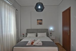 a bedroom with a bed with two towels on it at Lagouvardos Apartments in Marathopoli