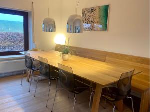 a conference room with a wooden table and chairs at Deichtraum - 1020 in Dahme