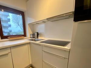 a small kitchen with a sink and a window at Deichtraum - 1020 in Dahme +14 photos