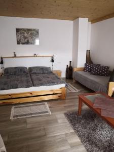 a bedroom with a large bed and a couch at Ubytování v soukromí Klima in Český Krumlov