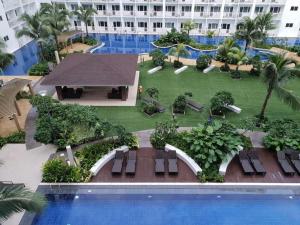 a view of a resort with a swimming pool at Shore 1 Residences MOA Staycation in Manila