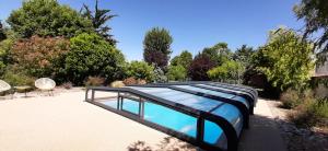 a house with a bed in the middle of a yard at LA ROCHELLE LODGE in Sainte-Soulle