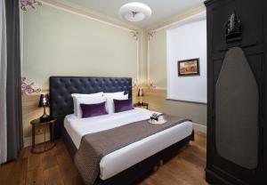 a bedroom with a large bed with purple pillows at Meroddi Galata Flats in Istanbul