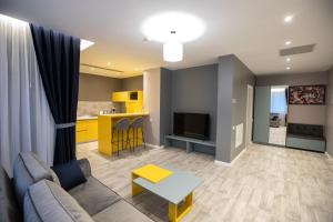 a living room with a couch and a table at Omnia Apartments in Iaşi