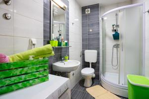 a bathroom with a sink and a toilet and a shower at Apartman Green in Lukavica +53 photos