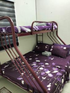 a couple of bunk beds in a room at Camelia Homestay in Seri Iskandar