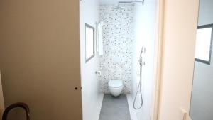 a bathroom with a white toilet in a room at Les Monges Palace Boutique in Alicante