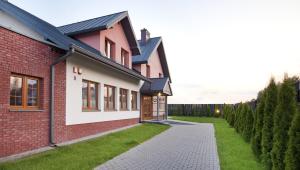 a brick house with a pathway in front of it at Artis Dom Gościnny in Zamość