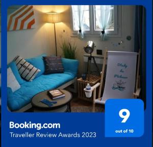 a living room with a blue couch and a table at Study du pêcheur in Trouville-sur-Mer