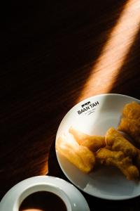 a plate of food on a table with a cup of coffee at Baan Tah On The Sea in Bang Sare