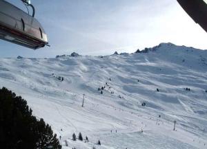 a snow covered mountain with people skiing on a ski lift at Jerzens Apartment 1 in Jerzens