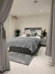 a bedroom with a large bed in a room at Lavish The Marble Apartment in Bury Saint Edmunds