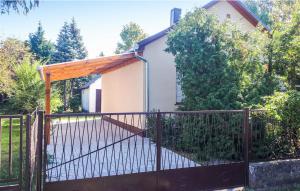a gate in front of a house at Zöld Liget Vendégház in Balatonfenyves