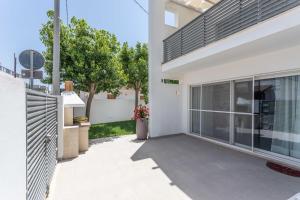 an empty patio of a house with a fence at Blu Marine Residence in Porto Cesareo
