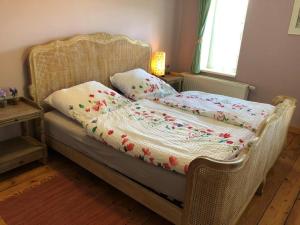 a wicker bed with pillows on it in a bedroom at Haus Nummer 1, Moselblick in Reil