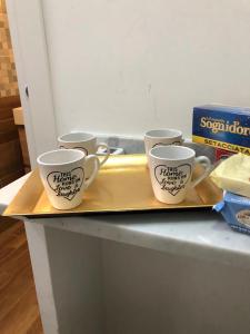 four coffee cups sitting on a tray on a counter at Al Vicolo di Ercolano in Ercolano